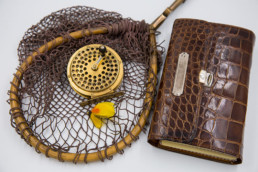 Gold Orvis Reel, Fishing Net and Fly Wallet